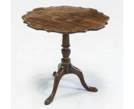 A GEORGE III MAHOGANY TRIPOD TABLE, the shaped circular "pie-crust" top above a spirally turned baluster standard raised on d