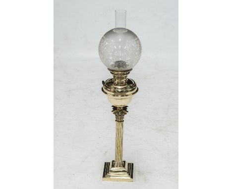 A BRASS COLUMNAR OIL LAMP, c.1900, with etched glass shade above a Corinthian column raised on a stepped square base. Height 