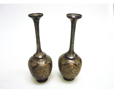 A PAIR OF 19th CENTURY MIDDLE EASTERN BRONZE VASES WITH SILVER AND COPPER OVERLAY, with slender necks and bulbous bodies on c