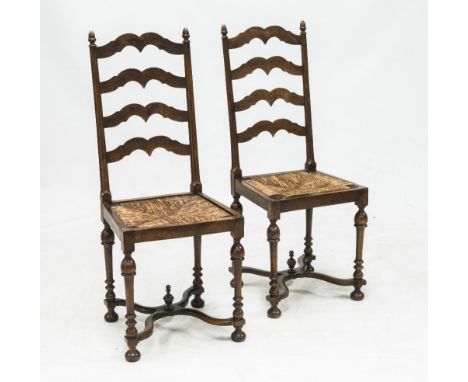 A PAIR OF 19th CENTURY PROVINCIAL MAHOGANY LADDER BACK RUSH SEATED CHAIRS, each with acorn finials above shaped ladder backs 