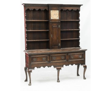 AN 18th CENTURY CLOCK DRESSER AND RACK, the upper section with a break front moulded cornice above a central integral brass f