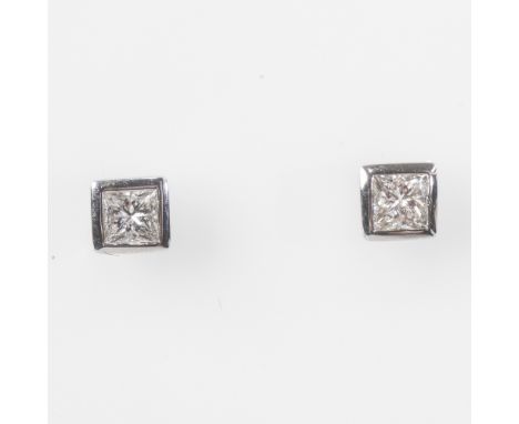 A PAIR OF DIAMOND EAR STUDS, each with princess-cut stone collet-set in 18ct white gold, post and butterfly fittings. 