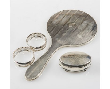 A GROUP OF SILVER COMPRISING: an oval ring box (marks rubbed); a pair of napkin rings, Birmingham 1918; and a hand mirror wit