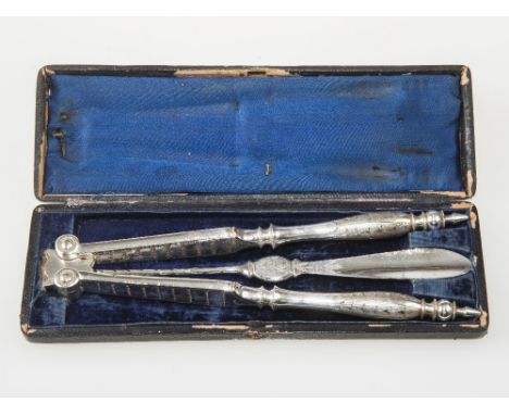 A CASED SET OF OYSTER CLAMPS AND FORK.
