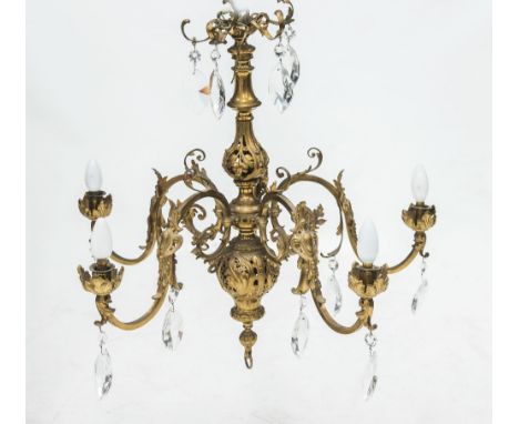 A GILT METAL FIVE LIGHT LUSTRE DROP CHANDELIER IN 19th CENTURY STYLE, the leaf cast standard issuing leaf and scroll cast arm