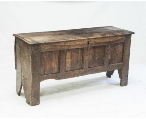 AN 18th CENTURY OAK FOUR PANEL COFFER, the moulded rectangular top over four panels, with plank sides, the stiles continuing 