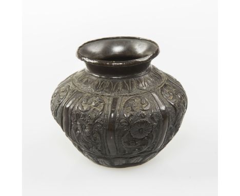 A SMALL JAPANESE BRONZE VASE, of baluster form, repousse with floral panels. 7.5cm