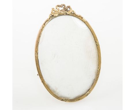 A SMALL GILT METAL OVAL PICTURE FRAME, c. 1840, with easel stand, 11cm high 