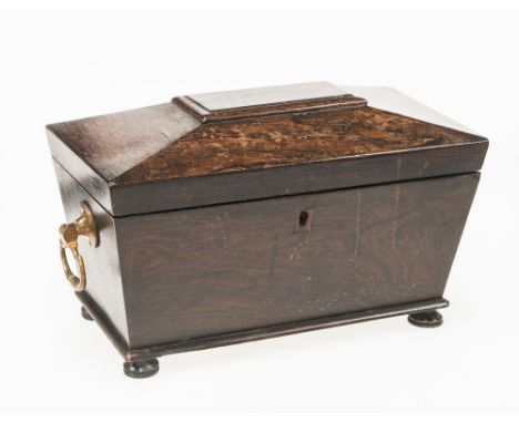 A REGENCY ROSEWOOD SARCOPHAGUS FORM CADDY, the hinged top opening to reveal a central glass bowl flanked by ivory handled lid