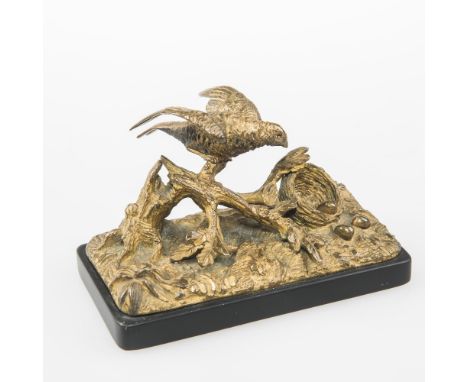 A FRENCH 19th CENTURY GILT-BRONZE MODEL OF A BIRD PERCHED ON A BOUGH, by an egg-filled nest, mounted on a black slate plinth.