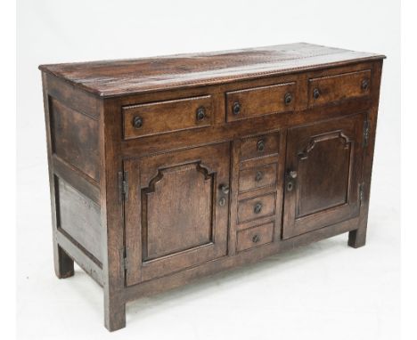 AN 18th CENTURY PROVINCIAL OAK DRESSER BASE, with an attractive patina and panelled to all sides, the moulded rectangular top