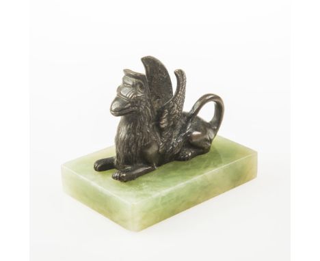 A PATINATED BRONZE MATCH HOLDER MODELLED AS A  RECUMBENT GRIFFIN on a green alabaster base, possibly French circa 1900, overa