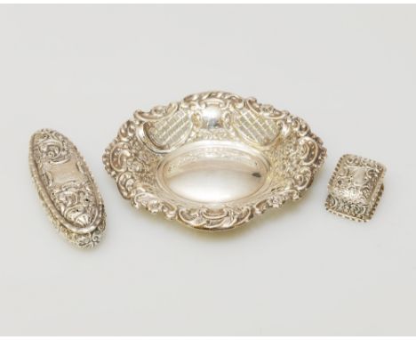 A VICTORIAN TRINKET DISH WITH EMBOSSED AND PIERCED DECORATION, BIRMINGHAM 1924, together with A SMALL RECTANGULAR SILVER EMBO