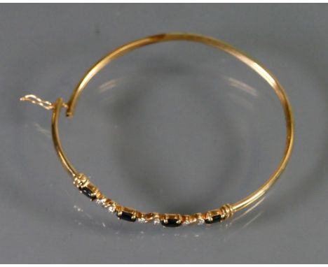 9ct gold Diamond and Sapphire bangle: 4.8g.