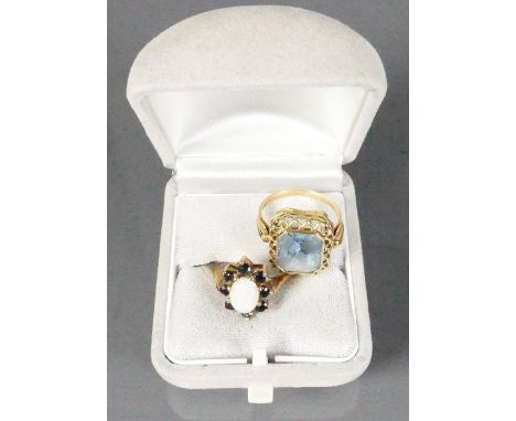 9ct gold ladies dress rings: One set with opal stone and the other yellow ring set with large grey stone, 6.5g. (2)