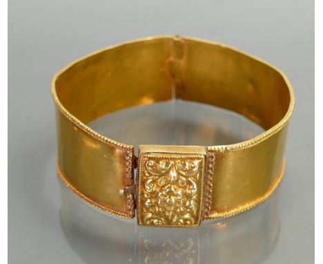 Bangle in yellow coloured metal: Weight 18.5g gross.  Metal tested as high carat.  Of overseas origin.  Out of shape, dented 