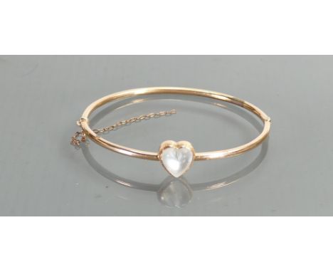 Moonstone & yellow coloured metal bangle:  Heart shaped gemstone 9mm wide. Gross weight 5.6g.  Tested as 9ct or better. 