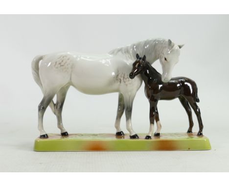 Beswick Mare and Foal on base: Beswick grey mare with dark brown foal on ceramic grass base model 1811.