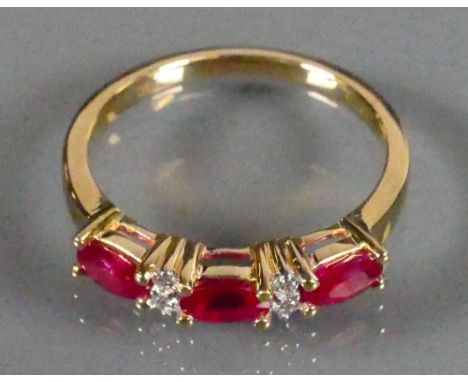 18ct gold ladies ring set with 3 Rubies and Diamond: Size N, 3.1g.