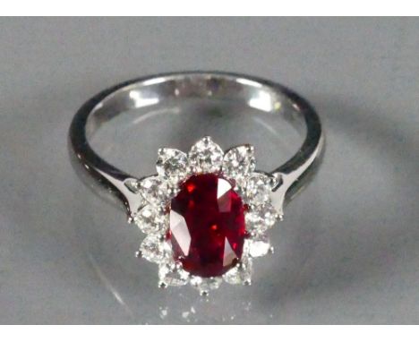 18ct White gold ladies ring set with an oval Garnet surrounded by Diamonds: Size M, 4.3g.