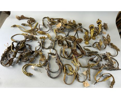 ARCHITECTURAL SALVAGE: A LARGE COLLECTION OF FRENCH ROCOCCO CURTAIN POLE SUPPORTS (QTY)To include a pair of Napoleon III ormo