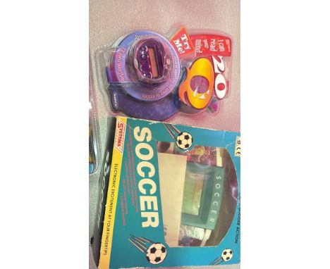 Four vintage handheld electronic games: Tomytronic 3D, Space Invaders, Soccer, 20Q