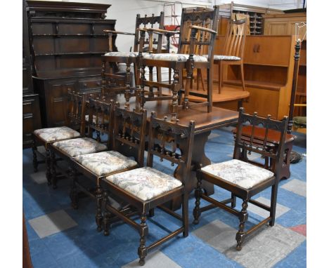 An Ercol Oak Rectangular Drawer Leaf Dining Table with Carved Border Together with Eight Ercol Dining Chairs 