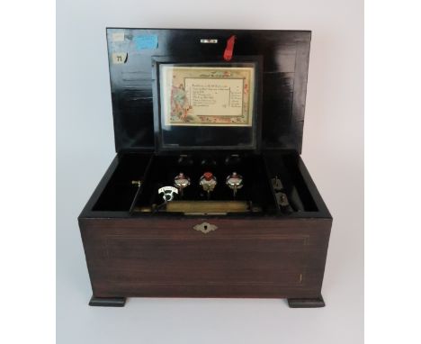 A LATE 19TH CENTURY INLAID MUSIC BOX with hinged lid, pinned list with three bells and butterfly hammers, 43cm wide, 20cm hig