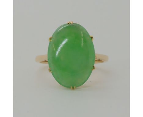 A 14CT GOLD CHINESE GREEN HARDSTONE RING approx dimensions of the hardstone 15mm x 11mm x 3.5mm, finger size K, weight 2.8gms