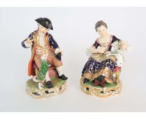 A PAIR OF DERBY PORCELAIN FIGURES early 19th century, modelled as a seated boy playing with a dog and a girl feeding a cat, b