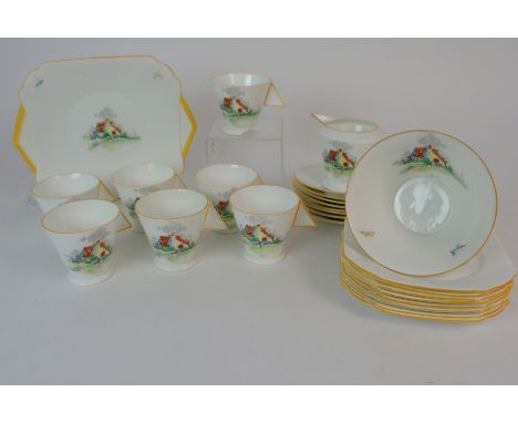 A SHELLY ART DECO COUNTRY COTTAGE TEASET decorated with a red roofed house in a garden, pattern R2115, comprising seven cups,