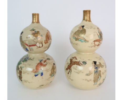 A PAIR OF SATSUMA DOUBLE GOURD VASES each painted with figures playing in gardens, with red and gilt collars, 24cm high Condi