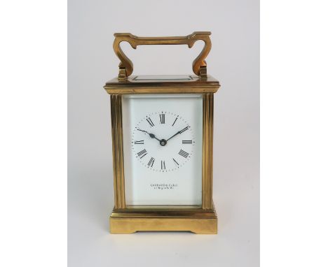 A GARRARD AND CO BRASS AND GLASS CARRIAGE CLOCK the white dial with Roman numerals and the movement marked E1245, 15cm high C