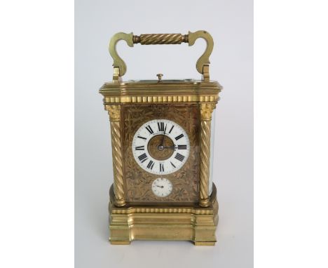 A HARMANN AND KOCH GLASS AND BRASS CARRIAGE ALARM CLOCK the white enamel dial with Roman numerals and subsidiary alarm dial, 