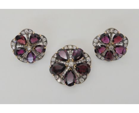 A SUITE OF GARNET AND DIAMOND LATE VICTORIAN JEWELLERY comprising of a brooch, diameter approx 2.8cm, of flower form with pea