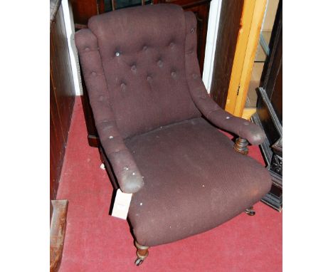 A late Victorian walnut framed and button back upholstered open armchair raised on squat turned forelegs to castors, width 67