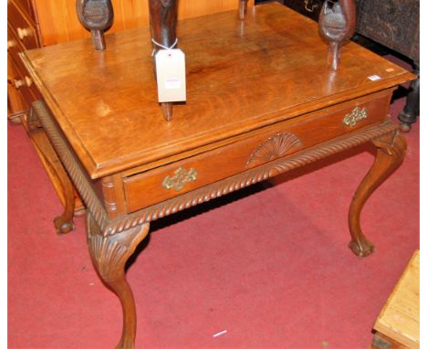 A Georgian style oak single drawer side table, having starburst decorated drawer over gadrooned edge, to shall capped cabriol