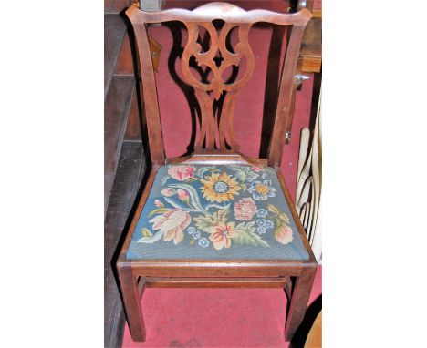 A pair of 19th century Chippendale style mahogany dining chairs, each having floral needlework drop-in padseats