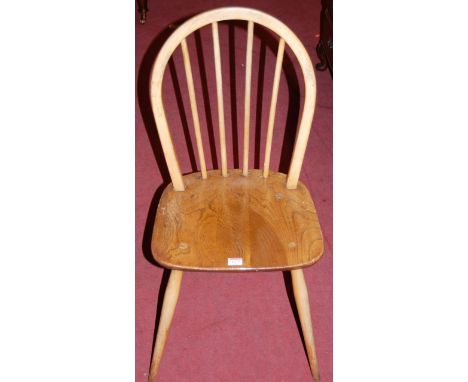 A set of four Ercol stained blond elm stickback kitchen chairs