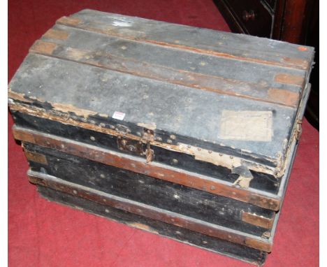 An early 20th century canvas clad, studded and metal bound dome-top travelling trunk, w.85cm; together with another canvas an