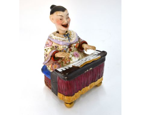 A Dresden-style Chinoiserie figure of a seated piano player with articulated head and arms, 18 cm high, 19th or 20th Century 