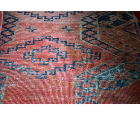 An Antique Afghan carpet, first quarter 20th century, traditional field of repeating guls on dusky dark red ground, 280 x 223