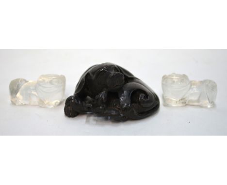 A metal scroll weight designed as a recumbent hound; and a pair of  glass or rock crystal Buddhist Lions, 4 cm long, possibly