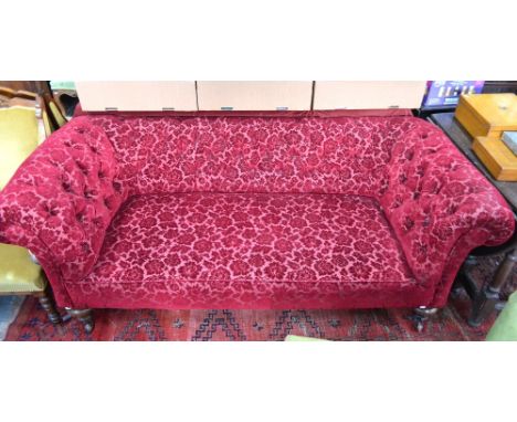 A Victorian button upholstered Chesterfield style sofa, raised on turned legs to ceramic castors - for re-upholstery