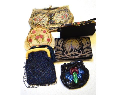 A tapestry evening bag with chain and gilded clasp, a rose-worked tapestry bag set with paste jewels, a black evening bag wit