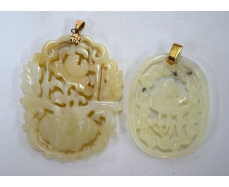 Two green jade pendants of reticulated form: one decorated with a flower arrangement; the other with a bird-of-paradise. Both