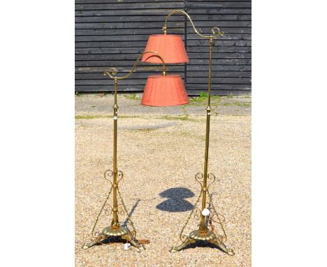 A pair of weighted lacquered brass telescopic standard lamp in the manner of W A S Benson having adjustable scroll arms raise