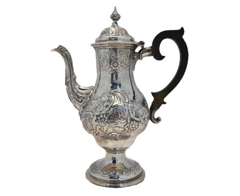 A George III silver baluster coffee pot, richly embossed and chased with sprays of flowers, scrolls and scales, Charles Wrigh