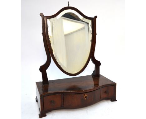 A 19th century mahogany shield shaped toilet mirror raised on a serpentine form three drawer base Condition Report Areas of c