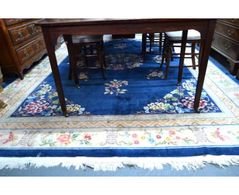 A Chinese blue ground carpet centred with a multi-coloured circular floral medallion and conforming spandrel corners within m